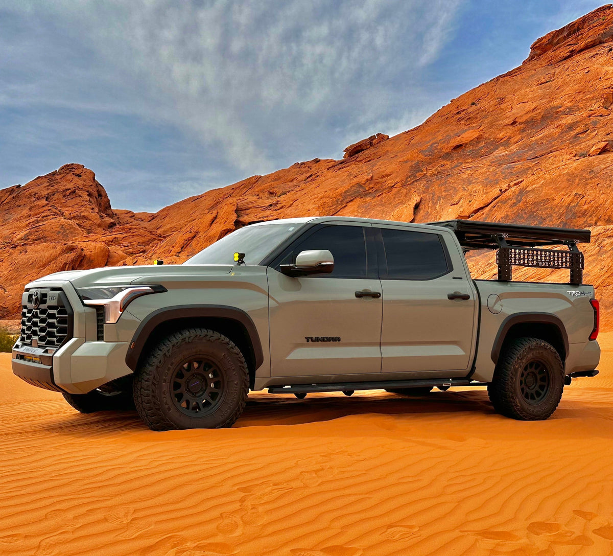 TRUKD T Series Double Decker Bed Rack two-level configuration mounted on a Toyota Tundra in a desert setting