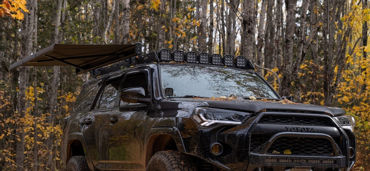 Kammok Crosswing awning deployed on a Toyota 4Runner in fall woods